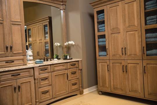 A large, organized and functional kitchen featuring a spacious vanity and a three-section cabinet with wooden doors.