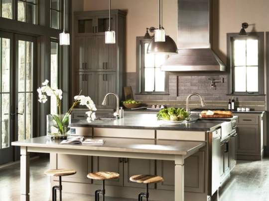 This modern kitchen is designed for both cooking and dining, equipped with appliances and adorned with decorative elements such as potted plants and vases.